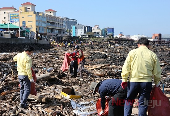 ▲ 제주 해안변으로 몰려든 해양쓰레기를 치우고 있는 모습. ©Newsjeju